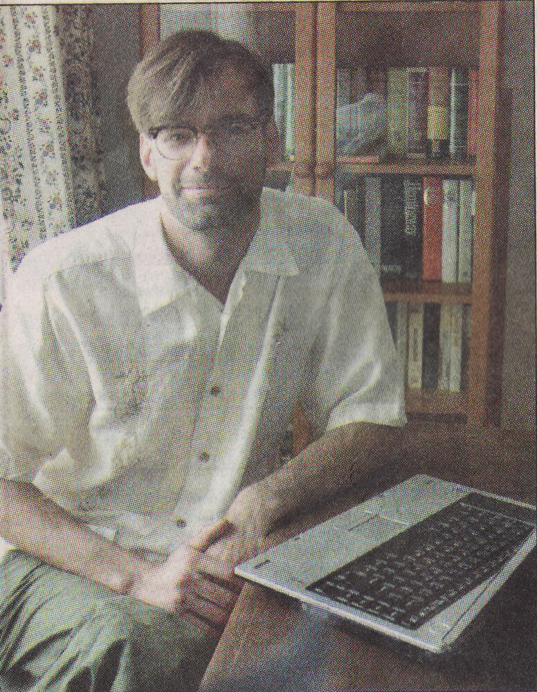 Michael Carolan, writer, at his bookcase, Belchertown home